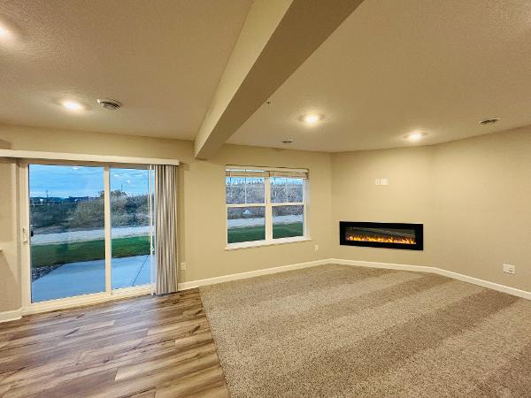 living room with fireplace and private backyard